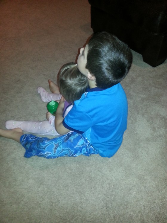 That big brother sure loves his little sister.